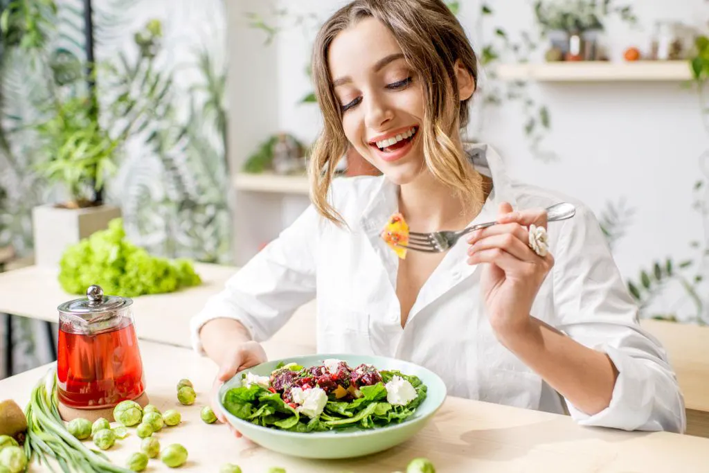 A smiling patient enjoying a healthy meal